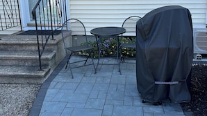 A patio with a covered grill, a table, and chairs. - 2 Bed/1 Bath Saunders Bay Gilford with boat slip. Walk to Meadowbrook for a show (Gilford)