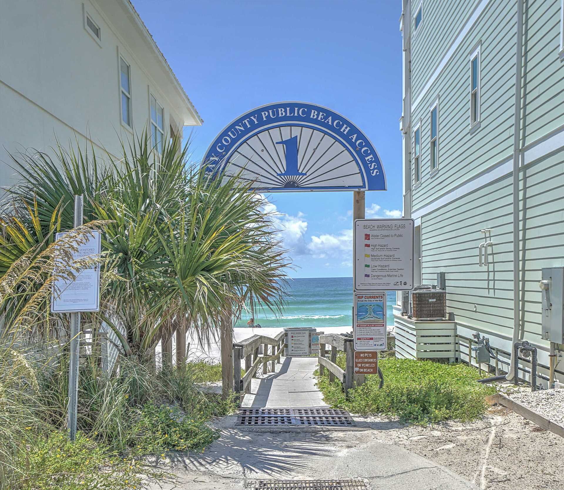 A beach entrance with a sign reading "COUNTY PUBLIC BEACH ACCESS".