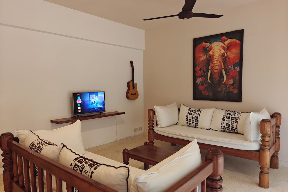 Basic Condo, 1 Bedroom, Garden View, Ground Floor | Living area | 42-inch Smart TV with digital channels, Netflix, streaming services