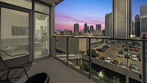 A balcony with a city view, a glass door, and a seating area. - Level - Fulton market Modern two bedroom two bath with full kitchen and balcony (Chicago)