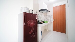 Studio | Private kitchen | Full-size fridge, stovetop - Compact And Tidy Studio At Puncak Dharmahusada Apartment (Surabaya)