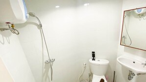 A bathroom with a toilet, bidet, and shower. - Homey And Good Choice Studio At Amartha View Apartment (Semarang)
