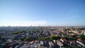 A densely packed urban area with numerous buildings and a clear sky. - Simple 2Br With Extra Bed At Menara Rungkut Apartment (Surabaya)