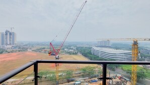 A construction site with cranes and buildings in the background. - Comfortable And Homey Living 2Br At Sky House Bsd Apartment (Pagedangan)