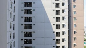 A multi-story building with numerous windows and balconies, featuring a modern architectural style. - Warm And Homey 2Br At Sentraland Cengkareng Apartment (Jakarta)