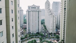 A high-rise residential building with multiple floors, balconies, and a central courtyard with trees and pathways. - Comfort Designed 2Br Apartment At Mediterania Palace Residence (Jakarta)