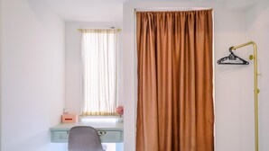 A room with a desk, chair, and a window with curtains. - Compact And Nice Studio Tokyo Riverside Pik 2 Apartment (Teluknaga)