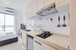 Studio | Private kitchen | Full-size fridge, stovetop, rice cooker - Fully Furnished With Cozy Studio Sky House Bsd Apartment (Pagedangan)