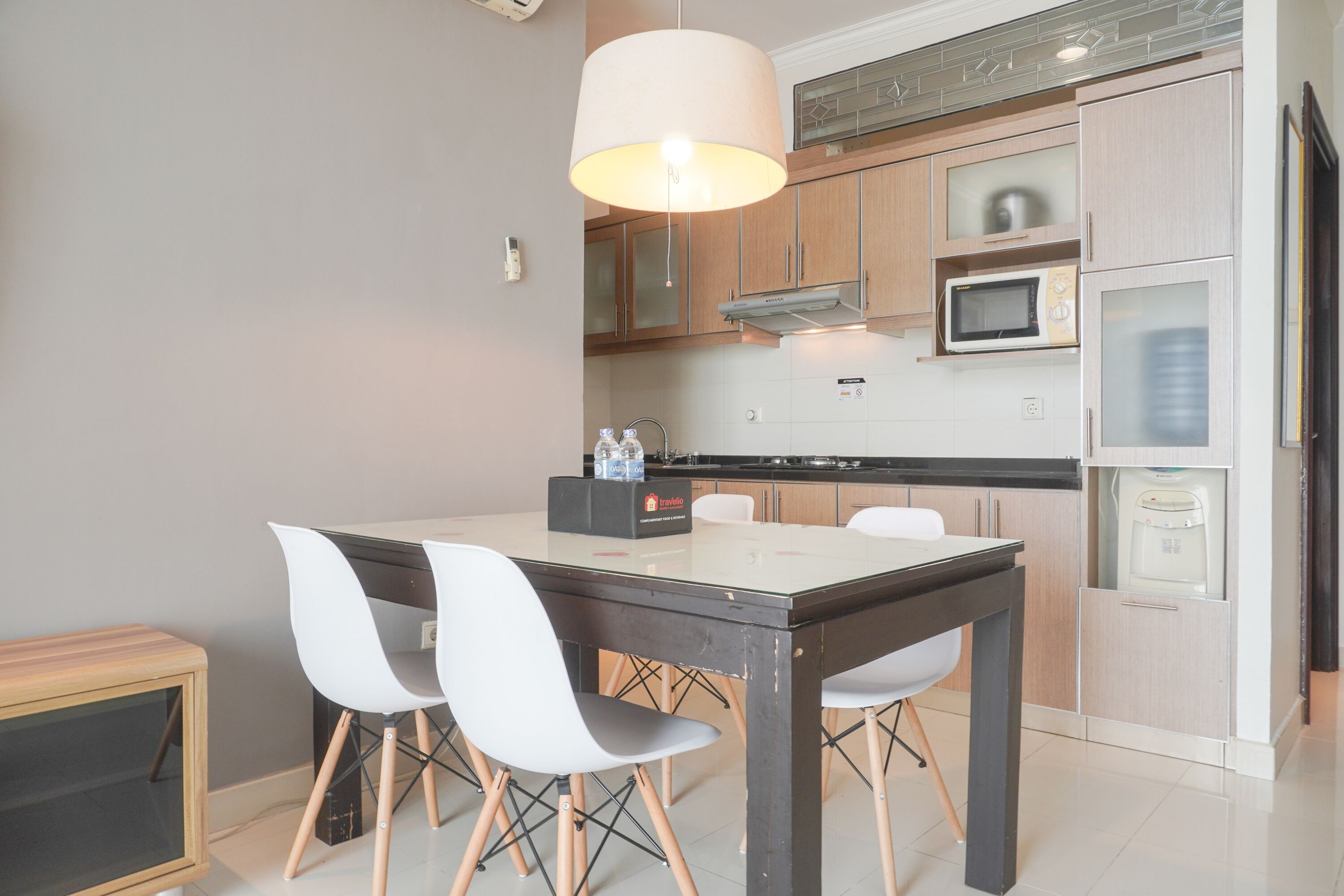 A modern kitchen with a dining table, chairs, and built-in appliances.