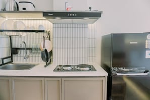 Full-sized fridge, stovetop, rice cooker, cookware/dishes/utensils