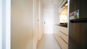 Full-size fridge, stovetop, rice cooker, cookware/dishes/utensils
