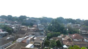 A densely packed urban area with various buildings, including residential houses and a modern structure.