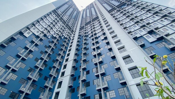 A high-rise building with multiple balconies and windows. - Minimalist 1Br With Extra Room At Evenciio Margonda Apartment (Depok)
