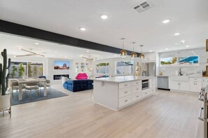 Enjoy meals in the kitchen with a central island, stainless steel appliances, and a dining area.