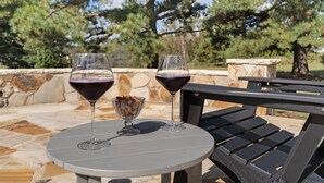 A round table with two wine glasses and a bowl of nuts. - Meadow Farm in Holly Springs, NC (Holly Springs)