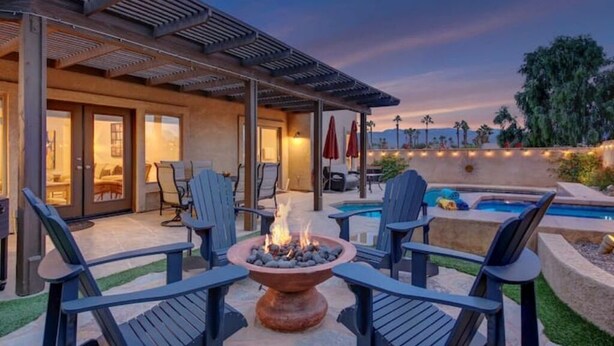An outdoor patio with a fire pit, seating, and a pool. - Sonrisa Sunshine-Pool,Spa,Walk to BNP 3BD #066685 (La Quinta)
