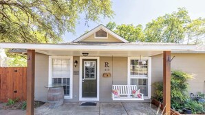 A single-story house with a covered porch, a front door, and a mailbox. - Two Unit Oasis With Two Hot Tubs (Fredericksburg)