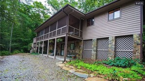 A two-story house with a covered porch and stone accents. - Murphy Mountain House - Creeks, Firepits & High Speed Internet! (Murphy)