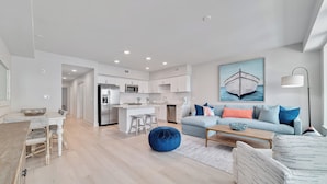A modern apartment with a kitchen, dining area, and living room. - "BRAND NEW" BEACHFRONT, OUTDOOR POOL, BEAUTIFUL VIEWS! (Gulf Shores)