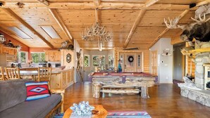 A spacious lodge interior with a wooden ceiling, a pool table, a sofa, and rustic decor. - The Moose Lodge. Stunning Mtn Views. Spa. Games. (Big Bear Lake)