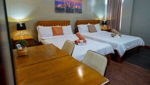 A hotel room with two beds, a wooden table, and a cityscape painting on the wall. - Life In Santa Maria (Santa Maria)