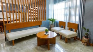 A modern living room with a wooden slatted partition, a sofa, two armchairs, and a coffee table. - Life In Santa Maria (Santa Maria)