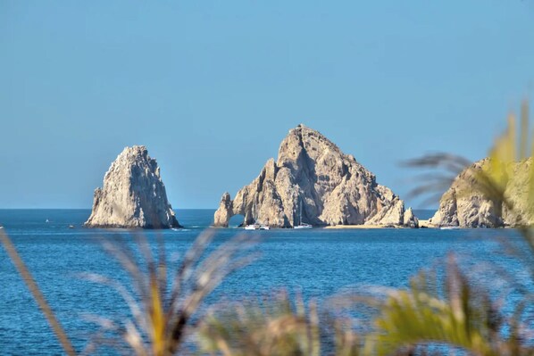A coastal landscape with rocky formations and calm sea.