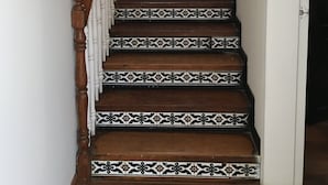 Una escalera con baldosas estampadas y barandillas de madera.