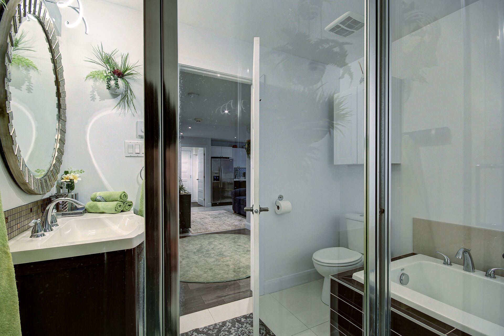 A modern bathroom with a glass shower enclosure, a white toilet, and a bathtub.