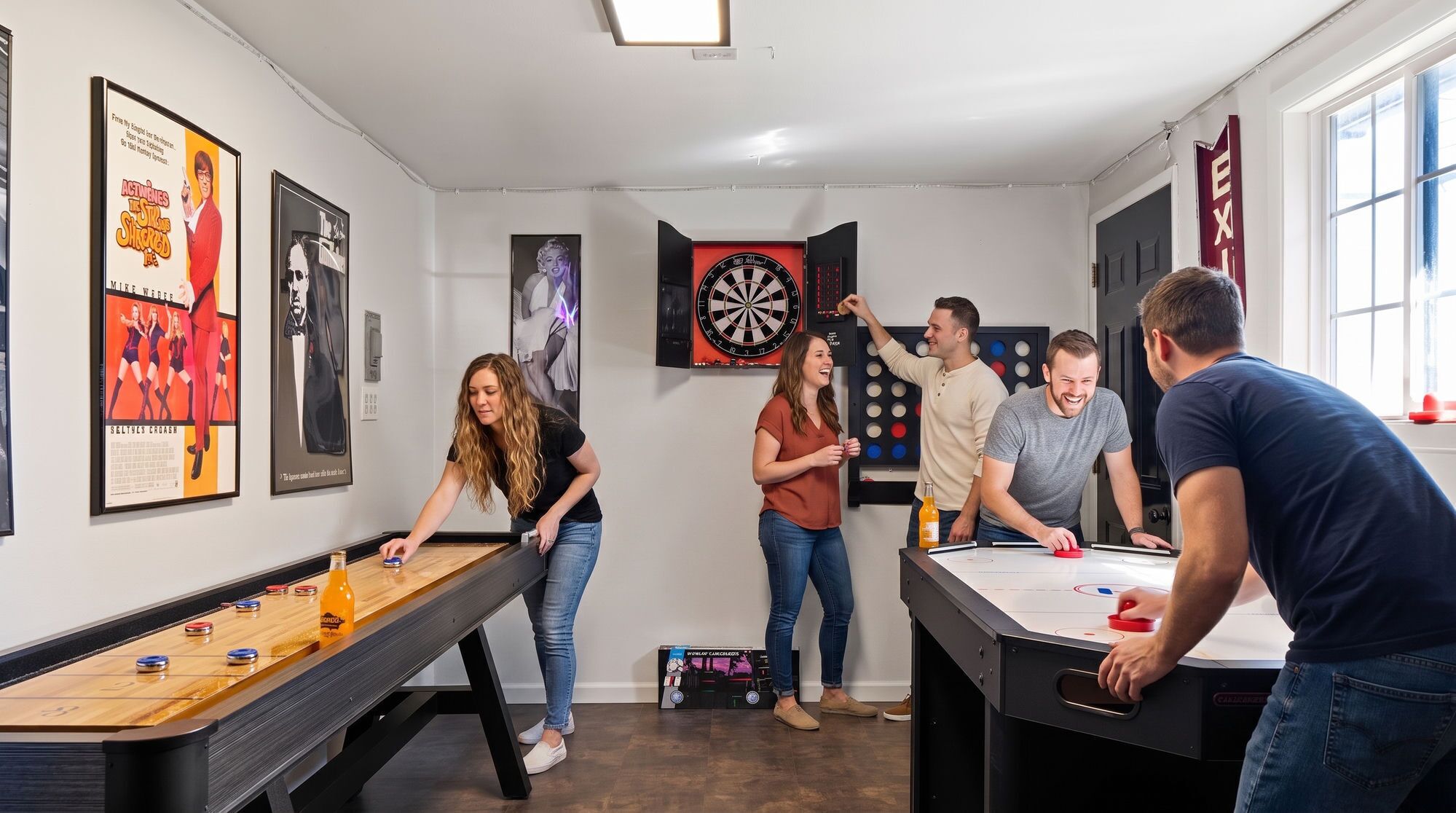 A room with a foosball table, dartboard, and a pool table.