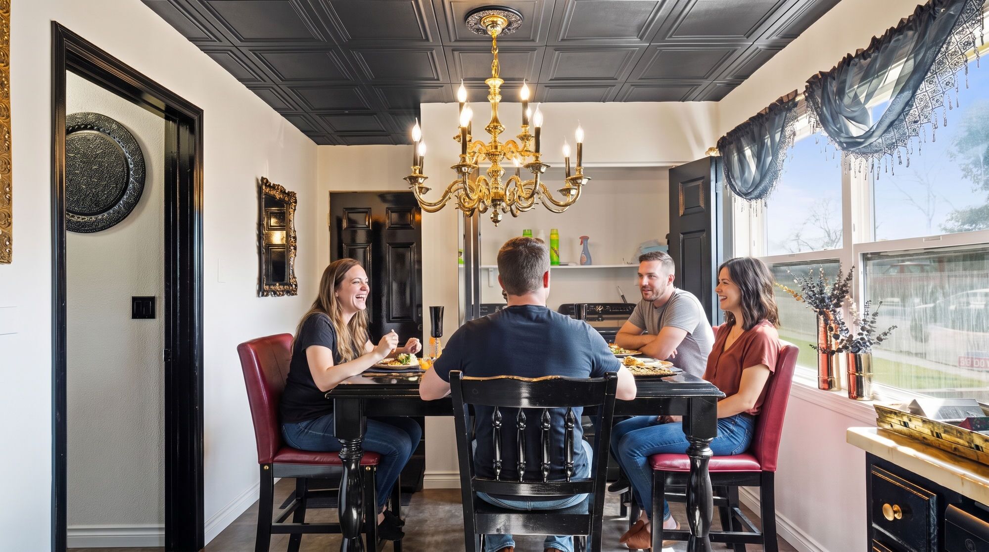 A dining area with a chandelier, a black dining table, and red chairs.