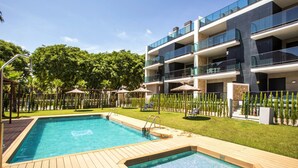 A modern hotel with a swimming pool, outdoor seating, and a well-maintained garden. - Golden Ray by Interhome (Jávea)