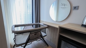 A modern hotel room with a large mirror, a desk, and a cushioned chair. - Mahya Hotel (Istanbul)