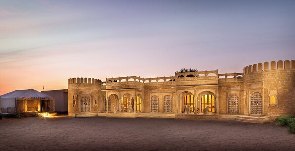 A historic building with arched doorways and a courtyard.