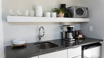Fridge, microwave, coffee/tea maker, cookware/dishes/utensils