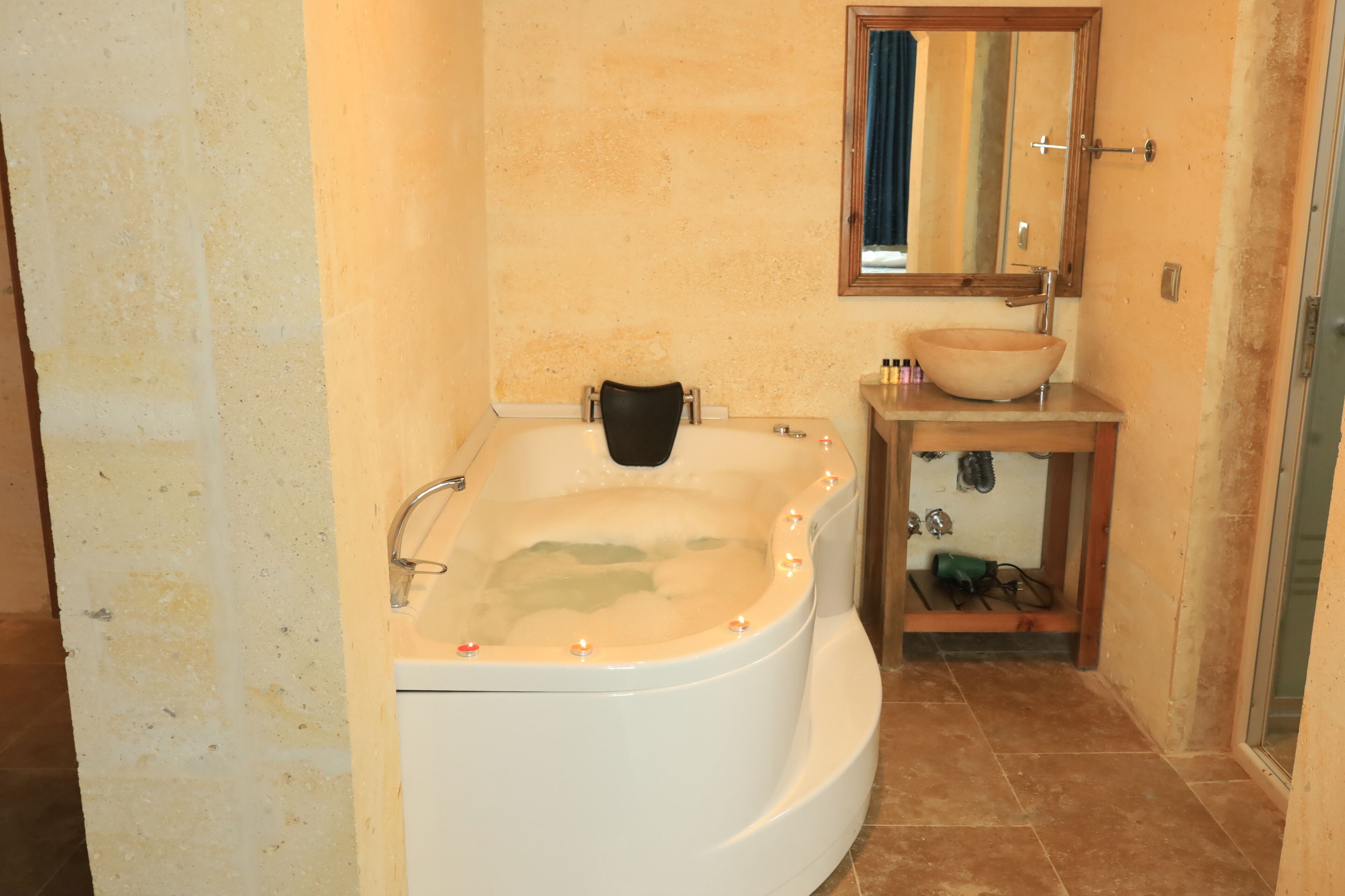 A bathroom with a bathtub, a sink, and a mirror.