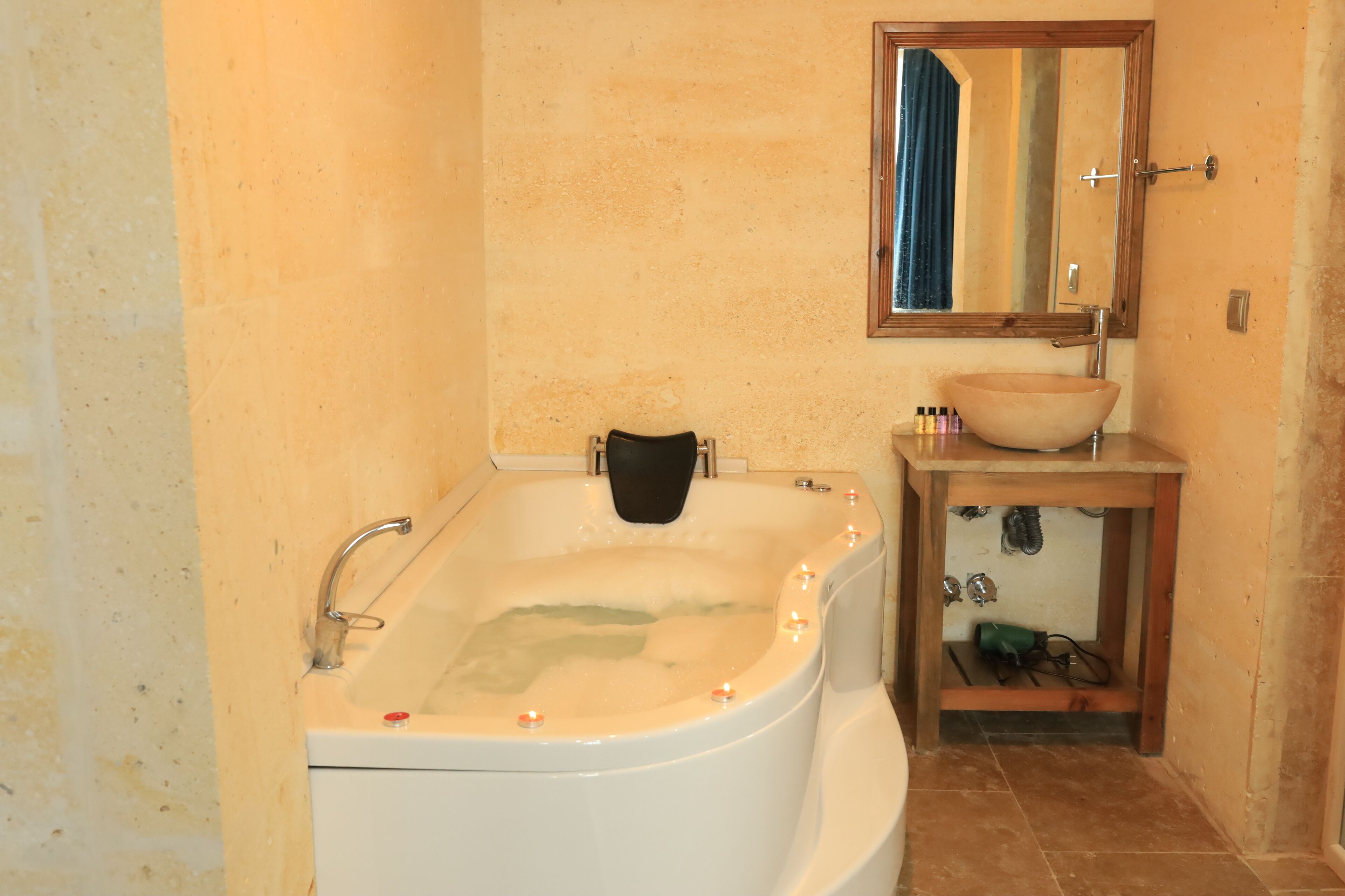 A bathroom with a bathtub, a sink, and a mirror.