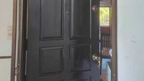 A black door with a blue sign above it. - Big Appartment 101 80 Sqm (Pattaya)