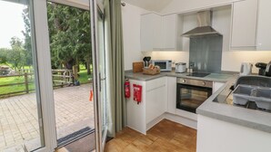 Eine moderne Küche mit einer Schiebetür zu einer Terrasse.