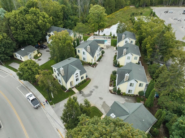A residential area with houses, a parking lot, and a body of water.