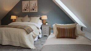 Experience a serene retreat with a cozy bed, nightstand, and soothing blue walls, complemented by abstract art pieces.