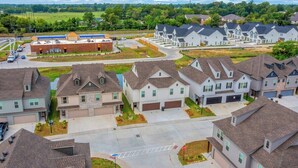 A residential area with detached houses, a central building with a blue roof, and a stop sign. - Purple Paws Pad for LSU Tigers on the Go -  CL5610 (Baton Rouge)