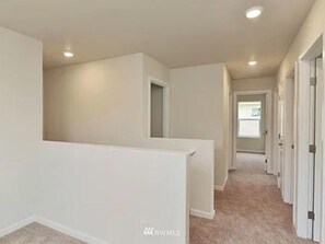 Corridors feature carpeted floors and doors leading to rooms.