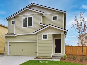 Welcome to this two-story home with a garage, front entrance, and porch area, set amidst a well-maintained lawn and secure fence.