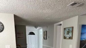 A hallway with wooden flooring, white walls, and a door leading to another room. - On the beautiful lake, it is close to the airport, malls,restaurants ,beach etc. (Lauderhill)