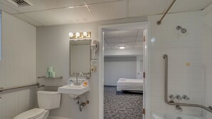 A modern bathroom with a toilet, sink, and shower.