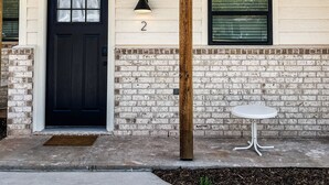 A house with a black front door, a small window with blinds, and a number '2' above the door. - Elegant studio near downtown (Abilene)