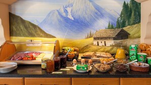 A breakfast buffet with a scenic mural of mountains and a house, featuring various food items and condiments. - 5-Star Vacation Rental in Wimbachtal, 45 sqm, Sleeps 2, Wi-Fi (Ramsau bei Berchtesgaden)