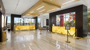 A hotel lobby with marble flooring, a reception desk, and a check-in counter. - Ocean View Wraparound Balcony and Rooftop Pool-CS1 (Hollywood)