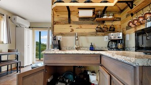 A kitchen with wooden cabinetry, a granite countertop, and a built-in oven.